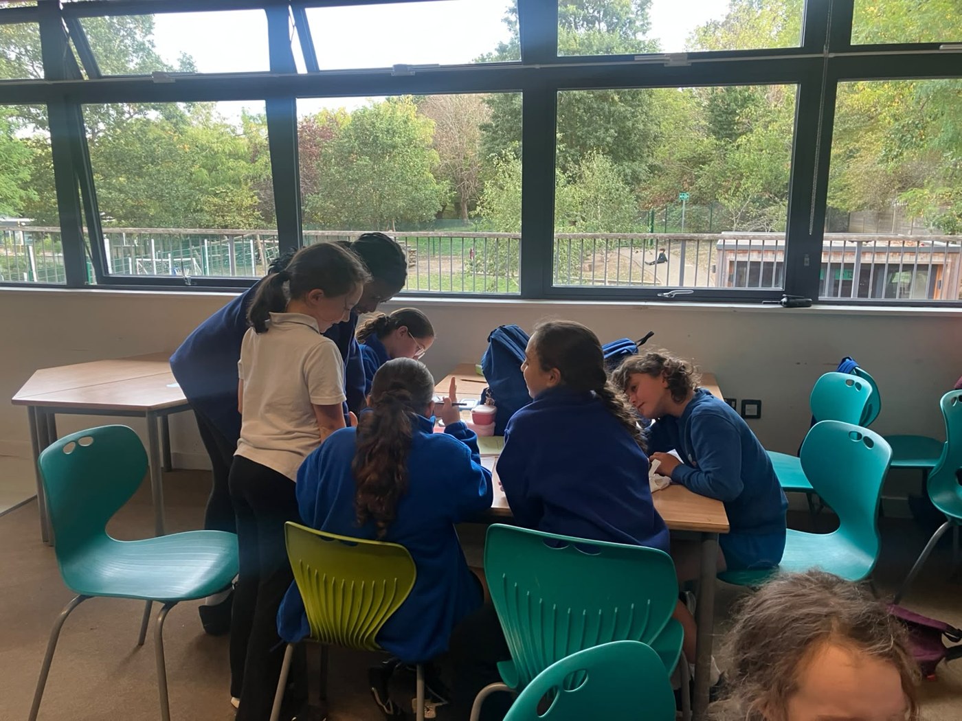 Children gathered around a table during a workshop